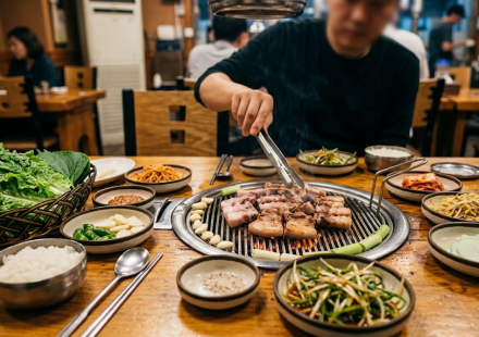 samgyeopsal name meaning Korean barbecue table with pork belly cooking on the grill
